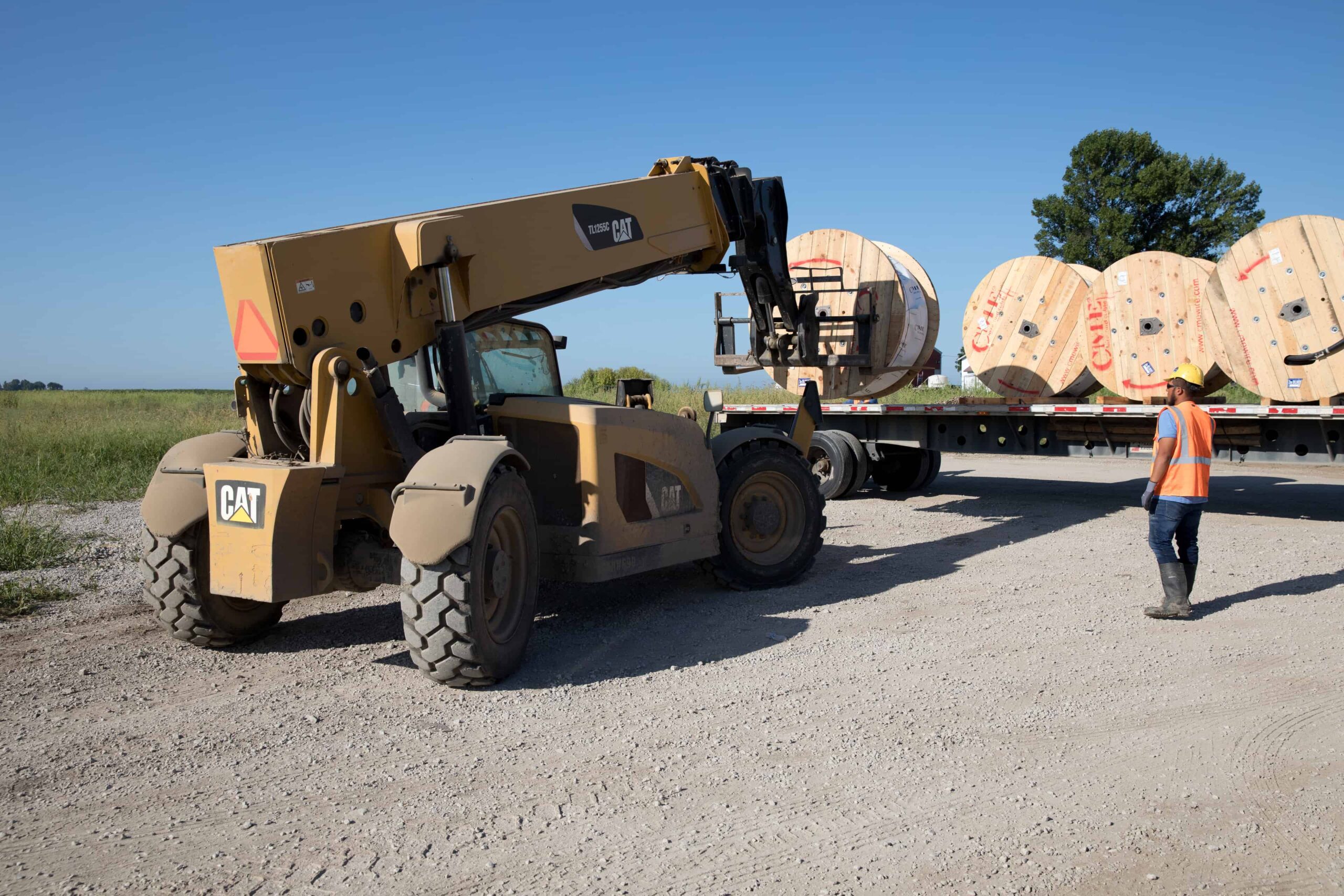 Workers unloading flatbed trailer