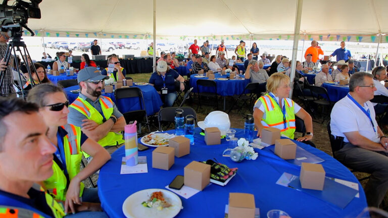 People sitting at tables at Wild Springs event
