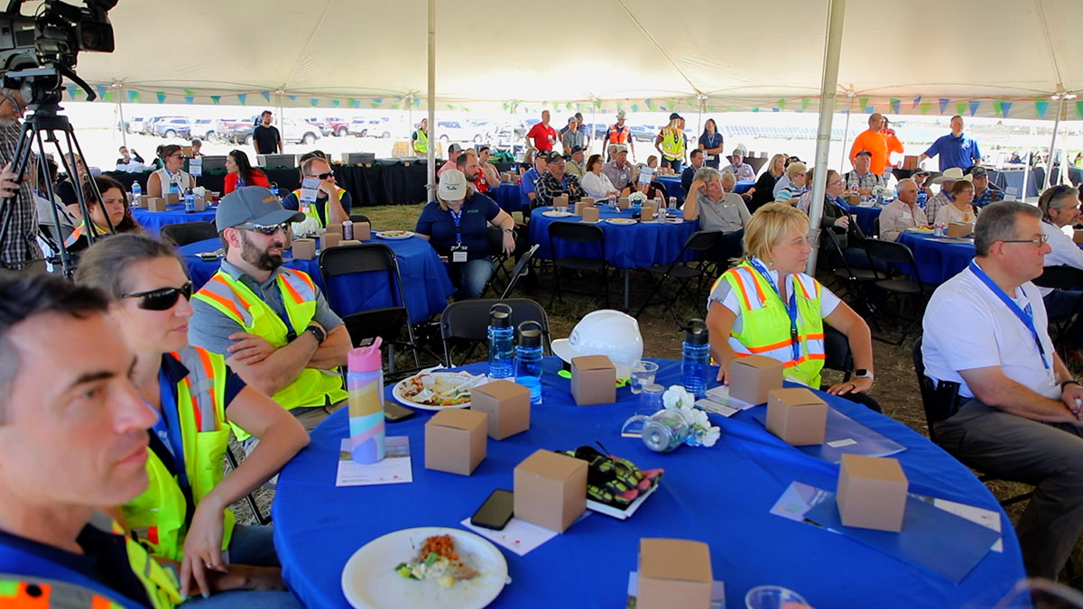 People sitting at tables at Wild Springs event