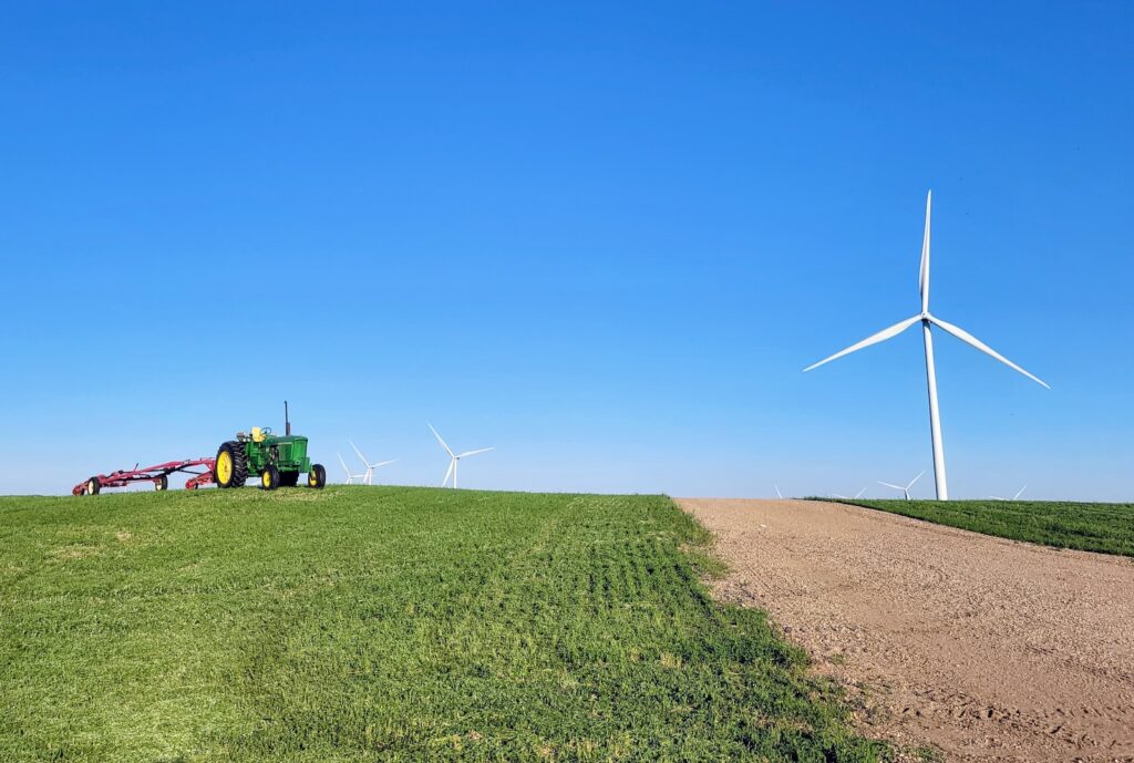 Tractor in field with wind turbine