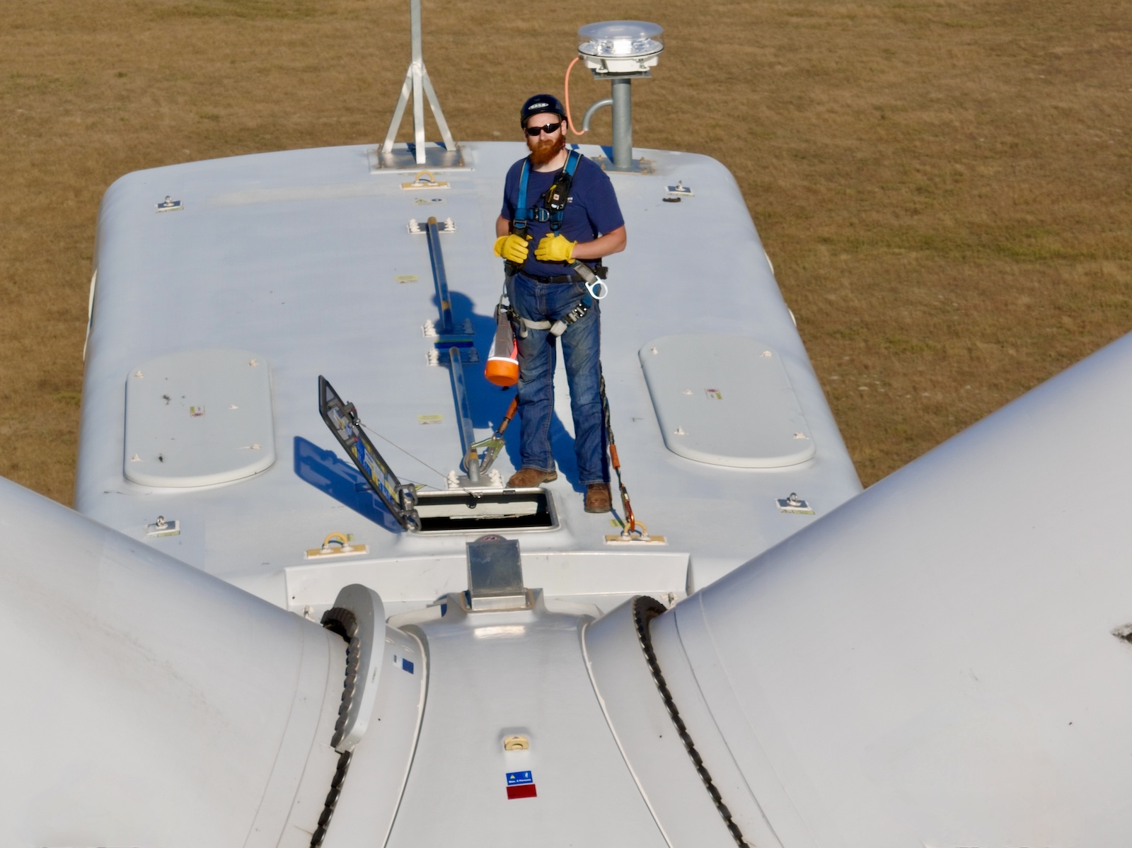 Man standing on wind turbine