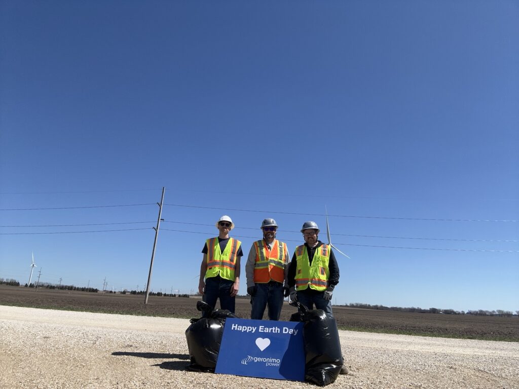 Adopt-A-Highway cleanup participants with Earth Day sign